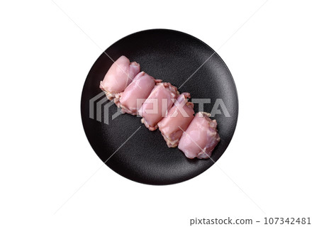 Fresh raw chicken thigh fillets with salt, spices and herbs 107342481