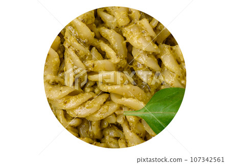 Delicious fresh pasta with green pesto sauce with basil Delicious fresh pasta with green pesto sauce with basil 107342561