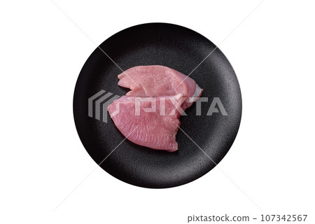 Raw turkey meat in the form of slices with salt, spices and herbs 107342567
