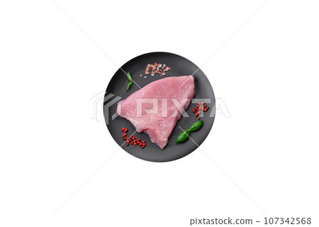 Raw turkey meat in the form of slices with salt, spices and herbs 107342568
