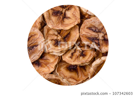 Round slices of sweet banana on a dark concrete background 107342603