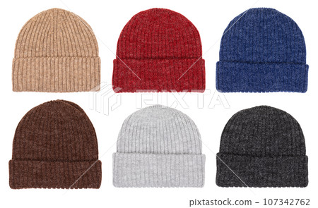 Winter knit cups of various colors isolated on white 107342762