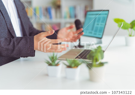 A man having a video conference 107343122