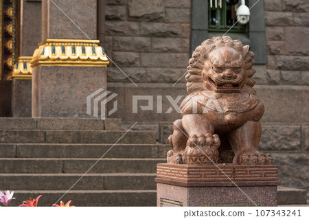 stone statue of a lion at the entrance to the Buddhist datsan Gunzechoinei stone statue of a lion at the entrance to the Buddhist datsan Gunzechoinei 107343241