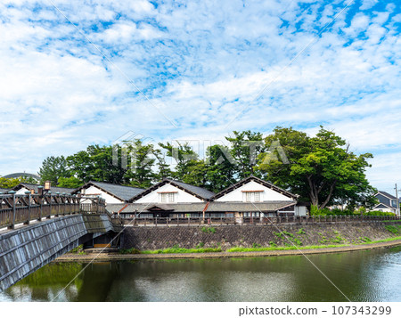 Beautiful Sankyo Warehouse historic building in Sakata city seen across the river during summer visit 107343299
