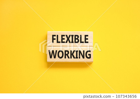 Flexible working symbol. Concept words Flexible working on beautiful wooden blocks. Beautiful yellow table yellow background. Business flexible working concept. Copy space. Flexible working symbol. Concept words Flexible working on beautiful wooden blocks. Beautiful yellow table yellow background. Business flexible working concept. Copy space. 107343656