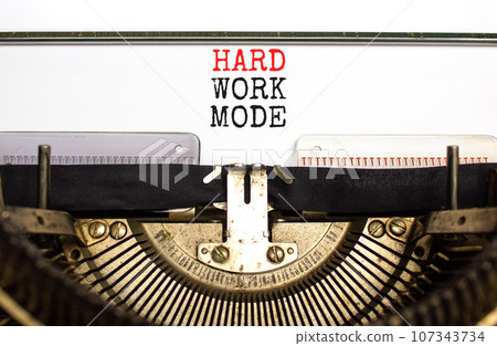 Hard work mode symbol. Concept words Hard work mode on white paper typed on old retro typewriter on beautiful white background. Business and Hard work mode concept. Copy space. 107343734