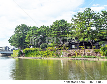 Beautiful Sankyo Warehouse historic building in Sakata city seen across the river during summer visit 107343836