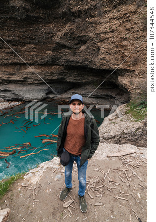 bearded Caucasian male traveler on background of river in Aksu canyon in Kazakhstan in spring 107344548