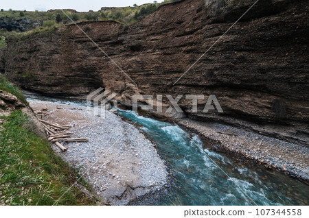blue water in river in mountains in Aksu canyon in Kazakhstan in spring blue water in river in mountains in Aksu canyon in Kazakhstan in spring 107344558