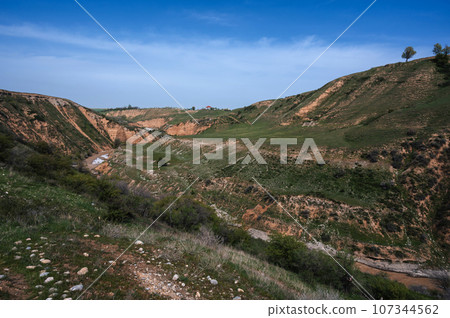 Landscape with canyon and Aksu river in Kazakhstan in spring under sky Landscape with canyon and Aksu river in Kazakhstan in spring under sky 107344562