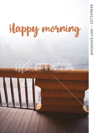 two cups of coffee standing on the balcony on a wooden house-the words of a happy morning two cups of coffee standing on the balcony on a wooden house-the words of a happy morning 107344648