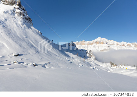 Winter Italy Dolomite mountains covered with snow Winter Italy Dolomite mountains covered with snow 107344838