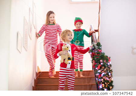 Kids running stair on Christmas morning Kids running stair on Christmas morning 107347542