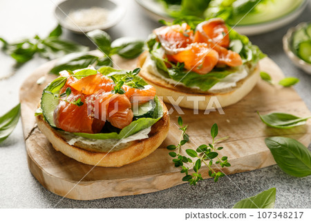 Salmon sandwiches with cream cheese, fresh romaine lettuce and cucumber 107348217