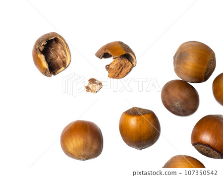 Hazelnuts on a white background. Nuts in a shell.  Healthy diet. Ingredients for preparing a healthy lunch. Broken walnut. 107350542