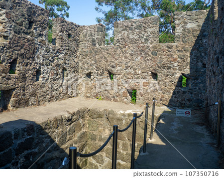 Remains of an old castle. Ancient fortifications made of stone. Museum in the open air. Remains of an old castle. Ancient fortifications made of stone. Museum in the open air. 107350716