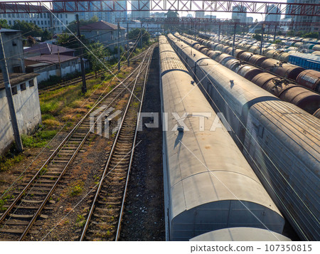 Railroad in the city. Many railway paths. Wagons and trains on the tracks. unloading station. Tank wagons. Railroad in the city. Many railway paths. Wagons and trains on the tracks. unloading station. Tank wagons. 107350815