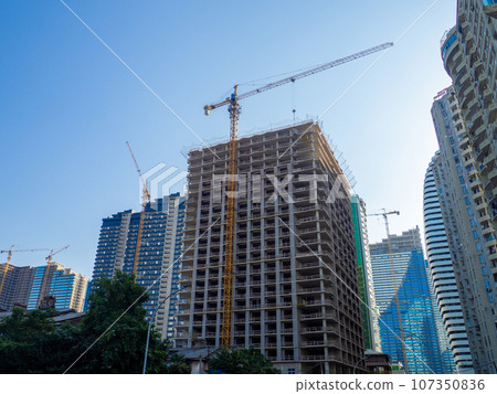 High-rise construction. Skyscraper under construction. Housing frame. Multi-apartment housing. Building cranes.  New area. 107350836