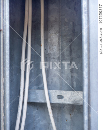 Wires inside. Electrical safety. Tape wrapping wires. Electricity of the net. Sticking wires inside the pole Wires inside. Electrical safety. Tape wrapping wires. Electricity of the net. Sticking wires inside the pole 107350877