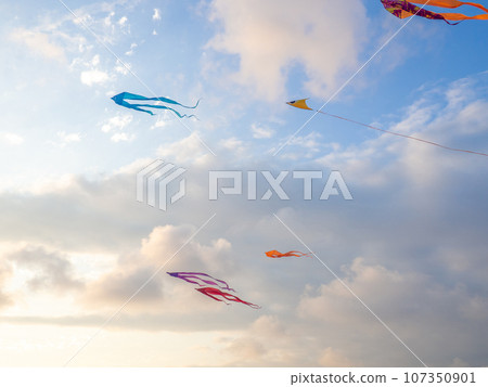 Lots of kites in the sky. Kite Festival. Colorful toys. Launching kites. Beauty in the sky Leisure entertainment. 107350901