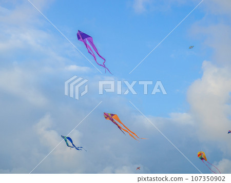 Lots of kites in the sky. Kite Festival. Colorful toys. Launching kites. Beauty in the sky Leisure entertainment. 107350902