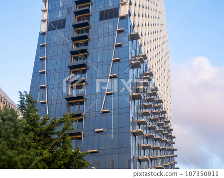Part of a high-rise building under construction. End of construction. Finished works. Facade of a new beautiful skyscraper. Modern engineering. Part of a high-rise building under construction. End of construction. Finished works. Facade of a new beautiful skyscraper. Modern engineering. 107350911