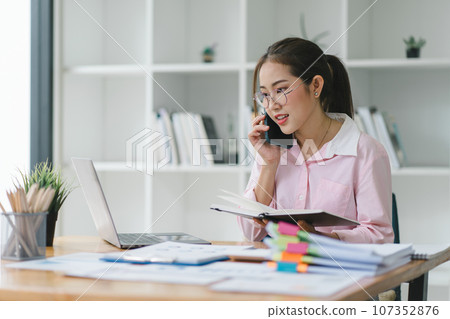 Portrait of beautiful asian secretary woman working with cellphone and laptop in office. 107352876