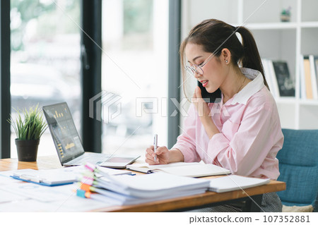 Portrait of beautiful asian secretary woman working with cellphone and laptop in office. 107352881
