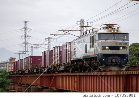 A new locomotive crossing the railway bridge A new locomotive crossing the railway bridge 107353991