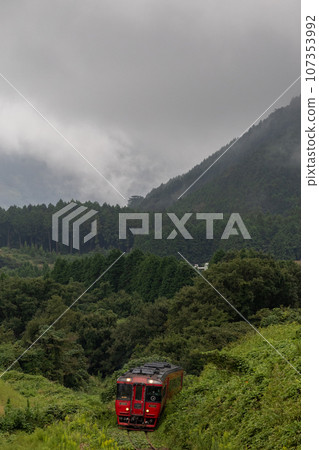 Red diesel train running in the fog Red diesel train running in the fog 107353992