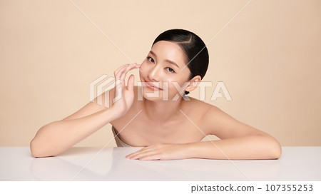 Beautiful young asian woman with clean fresh skin on beige background, Face care, Facial treatment, Cosmetology, beauty and spa, Asian women portrait. 107355253