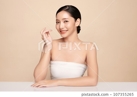 Beautiful young asian woman with clean fresh skin on beige background, Face care, Facial treatment, Cosmetology, beauty and spa, Asian women portrait. 107355265