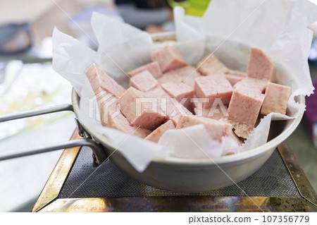 Cut SPAM ham frying in a frying pan Cut SPAM ham frying in a frying pan 107356779