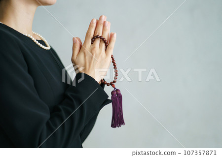 一位女士在葬禮上手牽手的個人資料照片 107357871