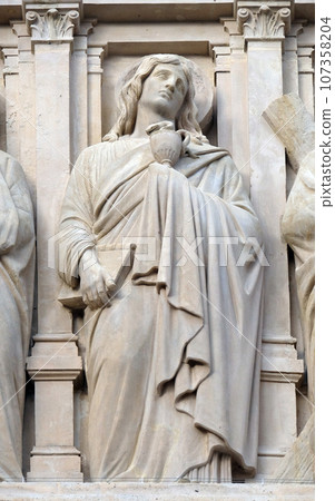 Saint John the Apostle, statue on the facade of Saint Augustine church in Paris, France Saint John the Apostle, statue on the facade of Saint Augustine church in Paris, France 107358204
