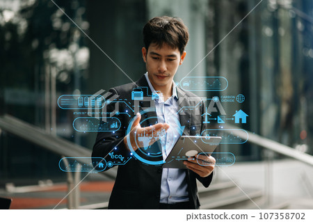Businessman working virtual tablet computer twith reduce CO2 concept with icons, global warming such as reforest green factory recycle in office. Businessman working virtual tablet computer twith reduce CO2 concept with icons, global warming such as reforest green factory recycle in office. 107358702