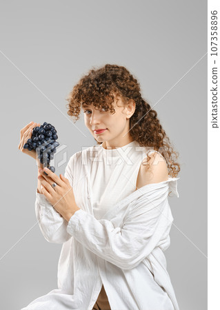 Portrait of cute woman with grape 107358896