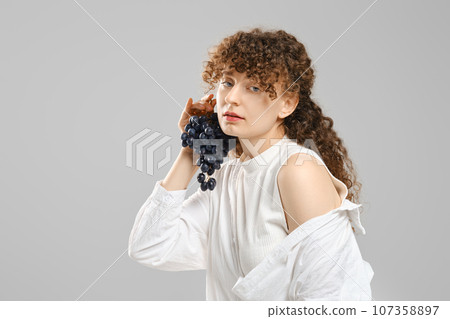 Portrait of woman with grape 107358897