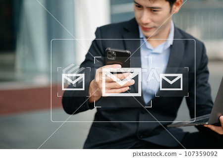 Man hands using Laptop, tablet typing on keyboard and surfing the internet with email icon, email marketing concept, send e-mail or newsletter, online working internet network technology. 107359092
