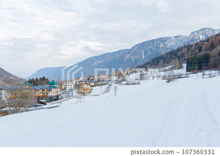 panoramic view on the little town in the snow valley 107360331