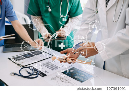 Medical technology network team meeting concept. Doctor hand working with smart phone modern digital tablet and laptop computer with graphics chart interface, with virtual icon . 107361091