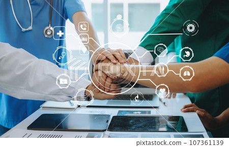 Medical technology network team meeting concept. Doctor hand working with smart phone modern digital tablet and laptop computer with graphics chart interface, with virtual icon diagram 107361139