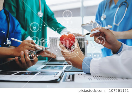 Medical technology network team meeting concept. Doctor hand working with smart phone modern digital tablet and laptop computer with graphics chart interface, with virtual icon diagram Medical technology network team meeting concept. Doctor hand working with smart phone modern digital tablet and laptop computer with graphics chart interface, with virtual icon diagram 107361151