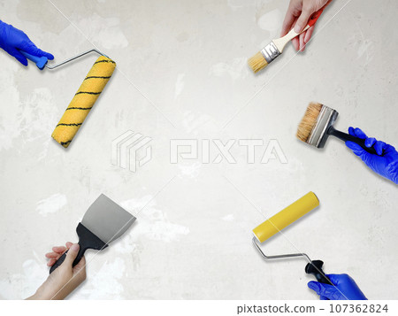 Repair and remodeling concept. hands with a brush, paint roller, spatula and other tools for repair white background, copy space Repair and remodeling concept. hands with a brush, paint roller, spatula and other tools for repair white background, copy space 107362824