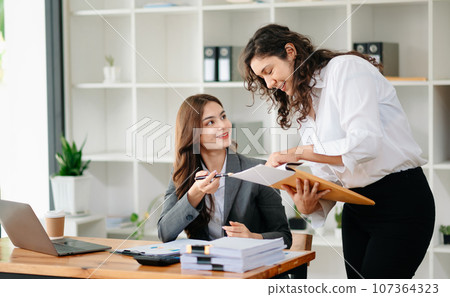 Portrait of success business people working together in home office. Couple teamwork startup concept. 107364323