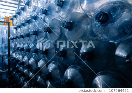 Plastic bottle for drinking water in production line of factory. Process of filling water into. Plastic bottle for drinking water in production line of factory. Process of filling water into. 107364421