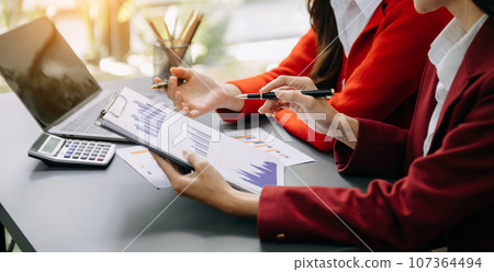 Businesswoman and team analyzing financial statement Finance task. with smart phone and laptop and tablet. Wealth management concept in office Businesswoman and team analyzing financial statement Finance task. with smart phone and laptop and tablet. Wealth management concept in office 107364494