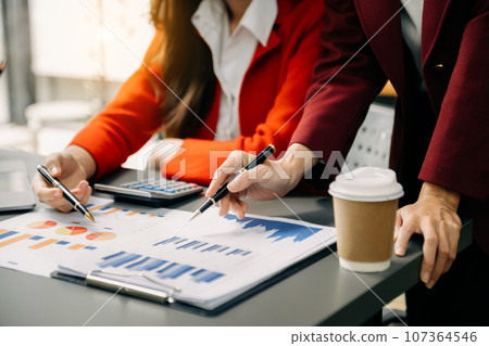 Businesswoman and team analyzing financial statement Finance task. with smart phone and laptop and tablet. Wealth management concept in office Businesswoman and team analyzing financial statement Finance task. with smart phone and laptop and tablet. Wealth management concept in office 107364546