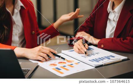 Businesswoman and team analyzing financial statement Finance task. with smart phone and laptop and tablet. Wealth management concept in office Businesswoman and team analyzing financial statement Finance task. with smart phone and laptop and tablet. Wealth management concept in office 107364615